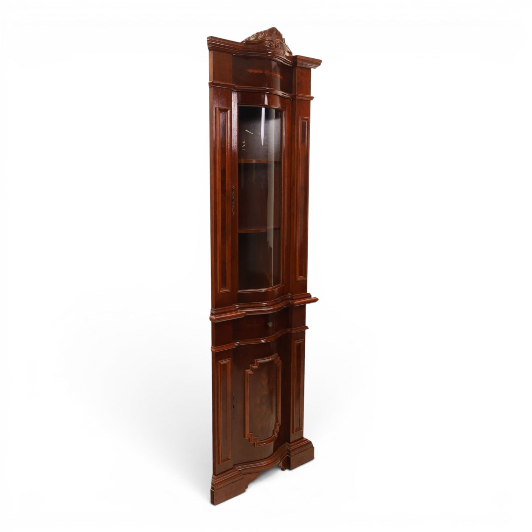 Victorian design mahogany corner cabinet, shaped carved cresting above bowed glazed upper door, with panelled side uprights, lower drawer over cupboard door decorated with floral marquetry, on plinth base