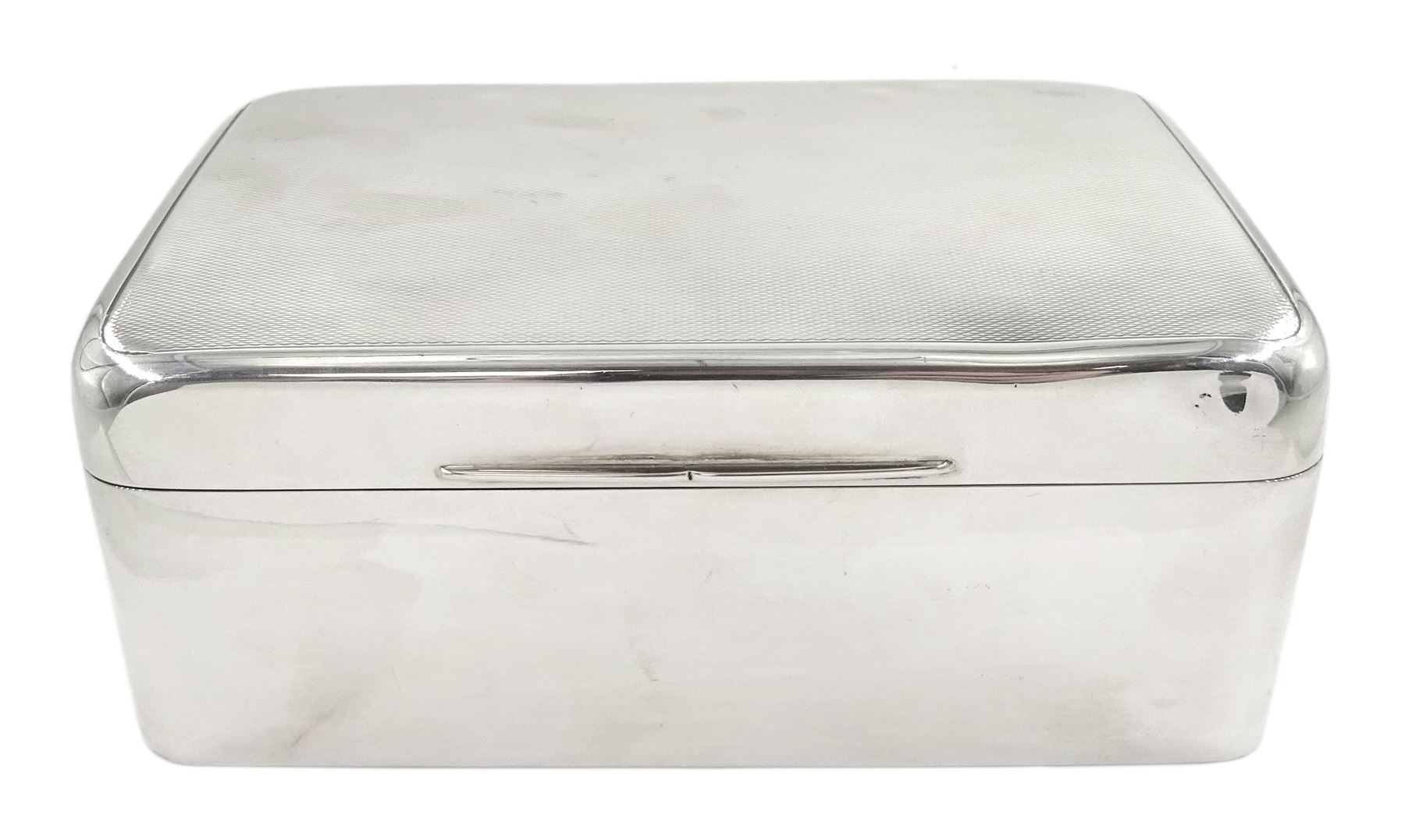 Small 1930's silver mounted cigarette box, of rectangular form with  engine turned decoration to hinged cover, opening to reveal a softwood lined interior, hallmarked James Dixon & Sons, Birmingham 1934, H5cm W13.5cm D9cm