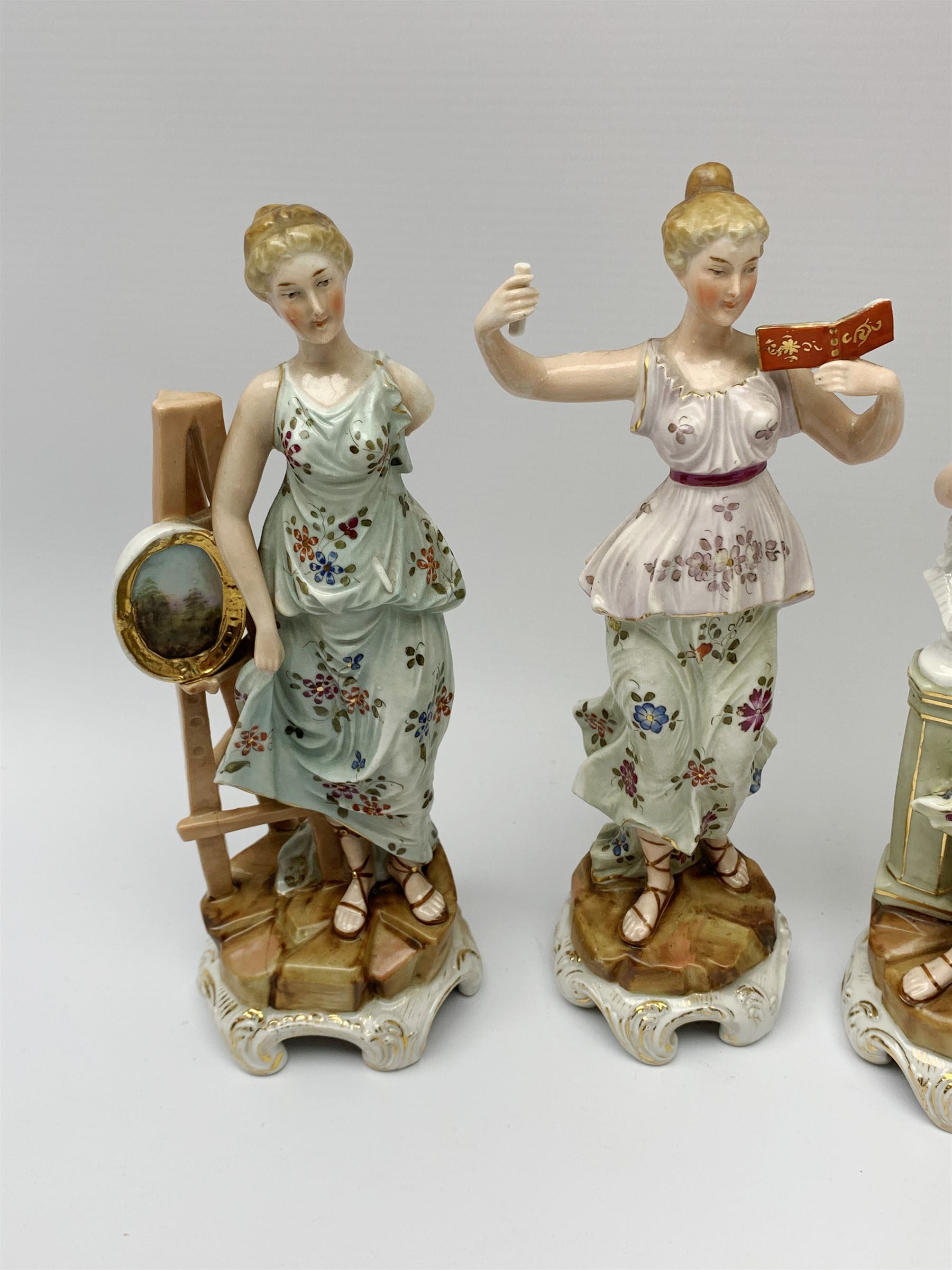 A group of five Continental figurines modelled as the arts, emblematic of music, painting, sculpture, literature, and theatre, each with spurious blue cross mark beneath, H22.5cm. (5). 