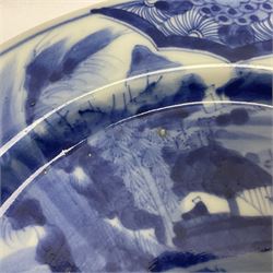 Japanese Meiji period Arita blue and white plate, of circular form, painted with riverside landscape and bird upon flowering branch, with character mark beneath, D24.5cm, together with two 18th century Chinese blue and white plates, each painted with floral design, each approximately D22.5cm
