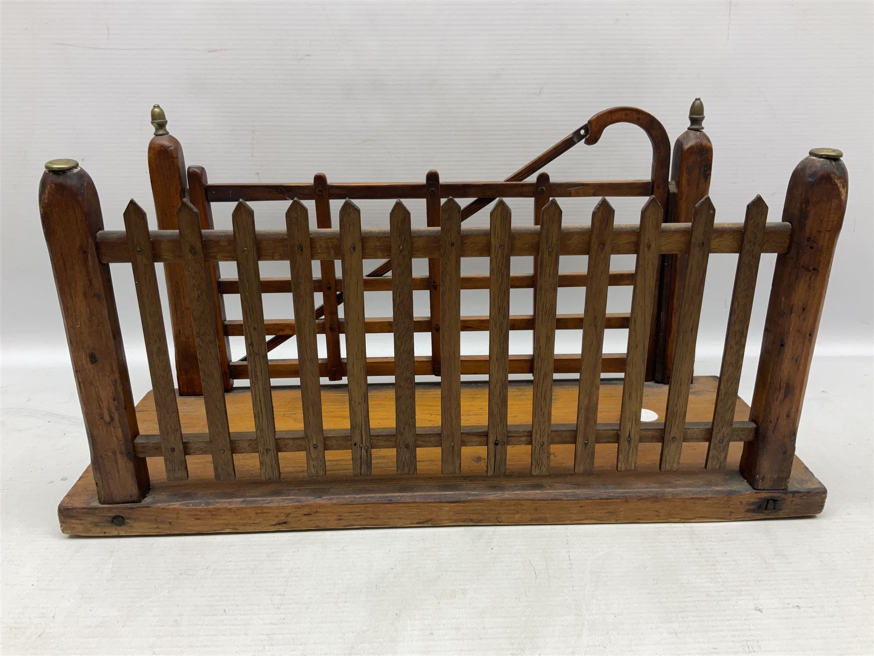 Early 20th century novelty letter rack modelled as a gate and picket fence, with brass post finials, on pine base, L43cm