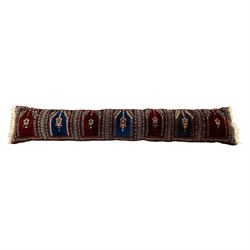 Long flatweave Kilim textile cushion, in crimson and decorated with geometric motifs and cotton fringe ends, 151cm, together with four modern hand-knotted rug mats with geometric designs, the largest 65x43cm, (5)