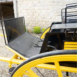 J. W. Thompson Dog Cart

A black and yellow painted two wheeled dog cart with elevated upholstered seat for two, buttoned black leather cushions, high back rail, folding front footboard, louvred sides, side steps, rear drop-down tailboard with chain stays, internal storage compartment, wooden spoked wheels, rubber tyres and shafts for a single horse. The wheel hubs are marked J W Thompson

Dimensions:
Overall length: 366 cm
Width: 160 cm
Height: 190 cm

Wheel Diameter:
Wheels: 139 cm

Seating:
Driver and passenger: 2