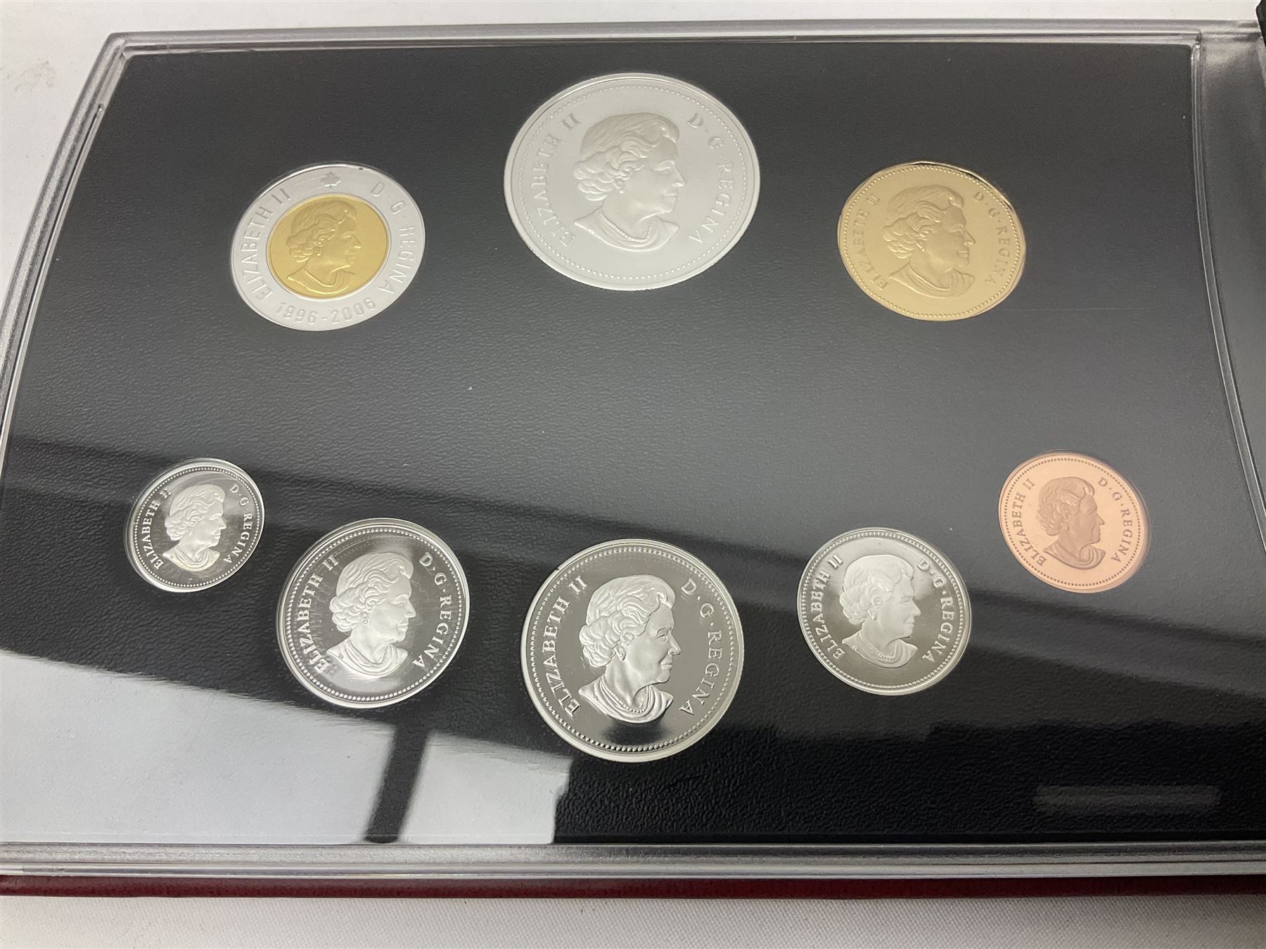 Queen Elizabeth II The Royal Canadian Mint 2006 silver proof dollar and two 2006 proof sets of Canadian coinage, all cased with certificates 