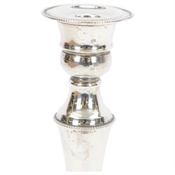 Pair of late 20th century silver mounted candlesticks, of tapering form with beaded rims, hallmarked Cooper Brothers & Sons Ltd, Sheffield 1972, H20cm