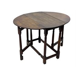 19th century oak gateleg table, the oval drop-leaf top formed of four planks, on turned column supports united by rectangular stretchers