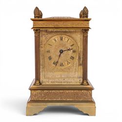 Early 20th century brass mantle clock, the face and case profusely engraved with floral sc...