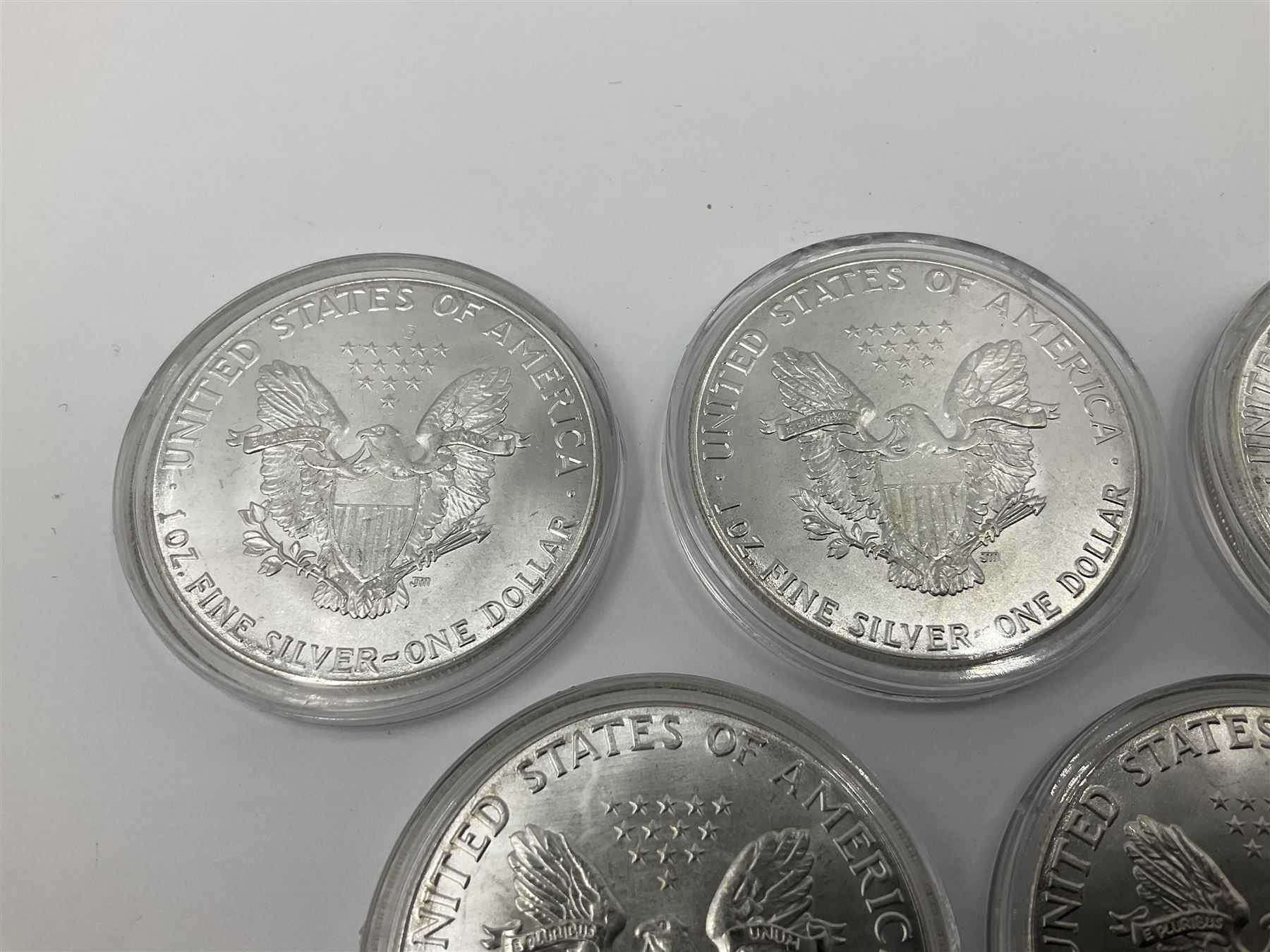 Five United States of America 1oz fine silver one dollar coins, dated 1986, 1987, 1988, 1989 and 1990