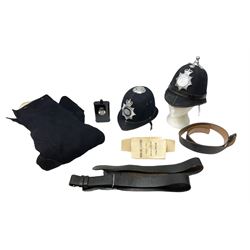 Two Queen's crown police helmets with plates for Metropolitan Police and Dorset & Bournemouth Constabulary; pair of mounted police breeches; two leather belts; and police style hand lamp in part box (6)