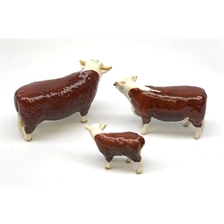 A Beswick Hereford Bull, Hereford Cow, and Hereford Calf, each with printed mark beneath, Bull and Cow marked CH of Champions. 