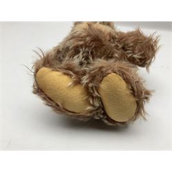 Steiff teddy bear with golden plush body, revolving head, applied eyes, vertically stitched nose and mouth and jointed limbs; button to left ear H26cm; and two other Steiff teddy bears, each with open mouth and button with tag to left ear (3)
