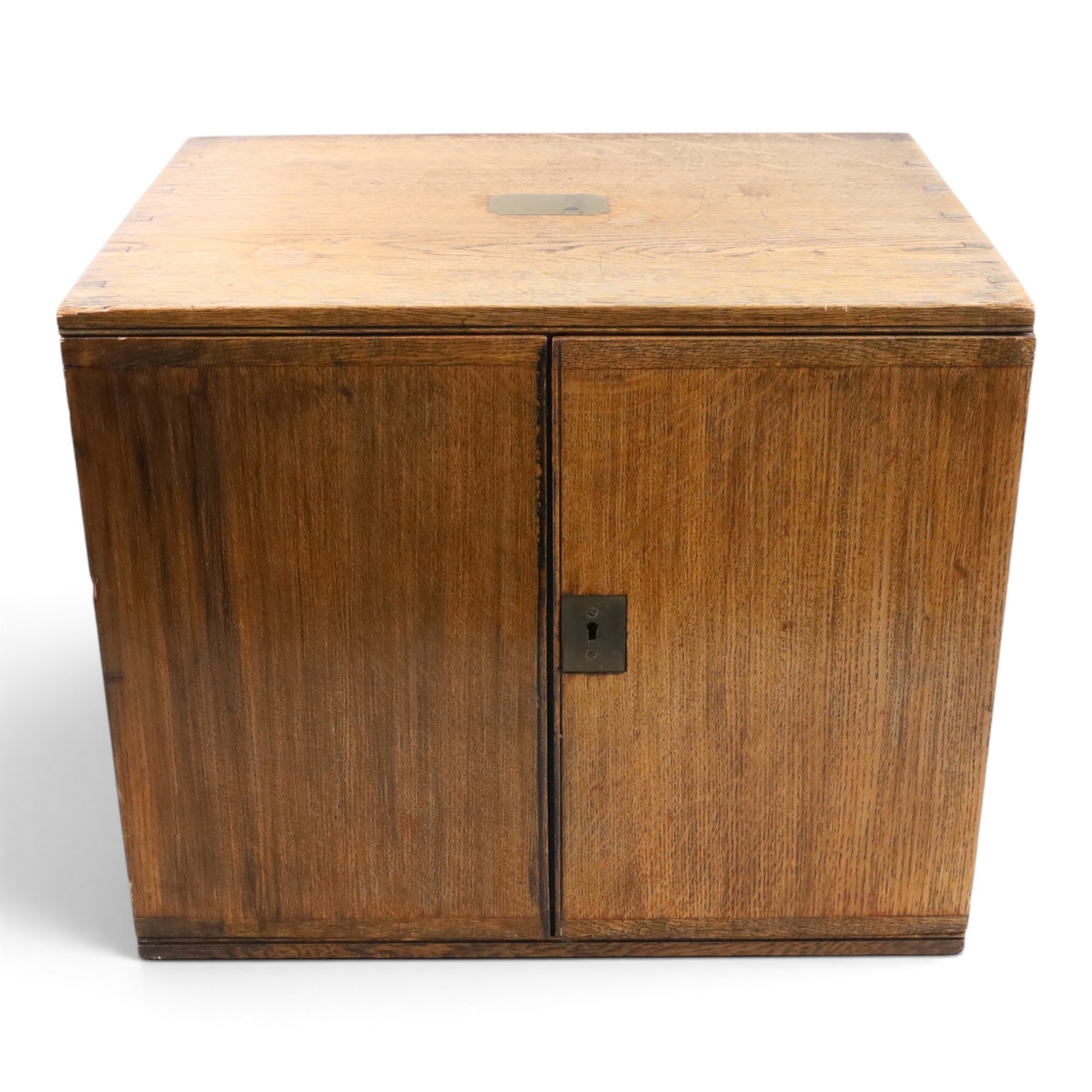 Ealy 20th century oak canteen, with five drawers behind double doors, four drawers containing a part set of silver plated Hanoverian pattern cutlery with engraved monograms and a set of twelve mother of pearl handled fruit knives and forks, the last drawer containing a collection of loose silver plated cutlery, canteen H39cm, W48cm