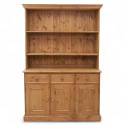 Late 20th century pine kitchen dresser, the upper section with open shelves and tongue and groove back, over a triple cupboard base with three drawers, turned wooden knobs throughout