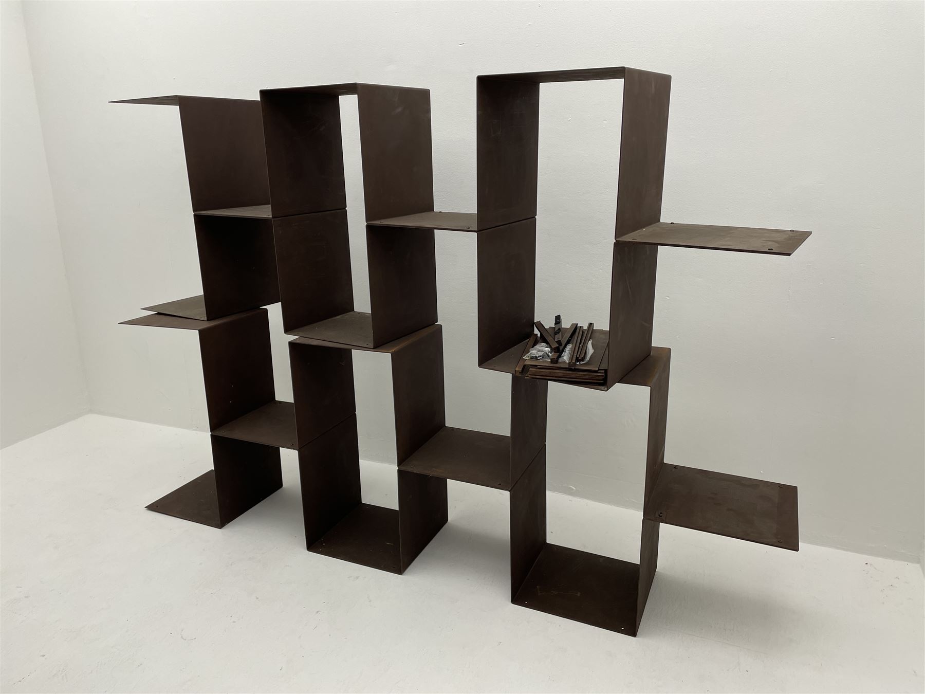 Retailed by The Conran Shop - four sectional modular shelving units, rusted metal finish, each unit - W212cm, H71cm, D33cm