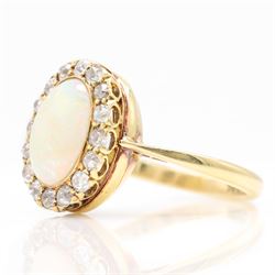 Early 20th century gold opal and diamond cluster ring, single oval cabochon opal, surrounded by sixteen old cut diamonds, stamped 18ct, total diamond weight approx 0.65 carat