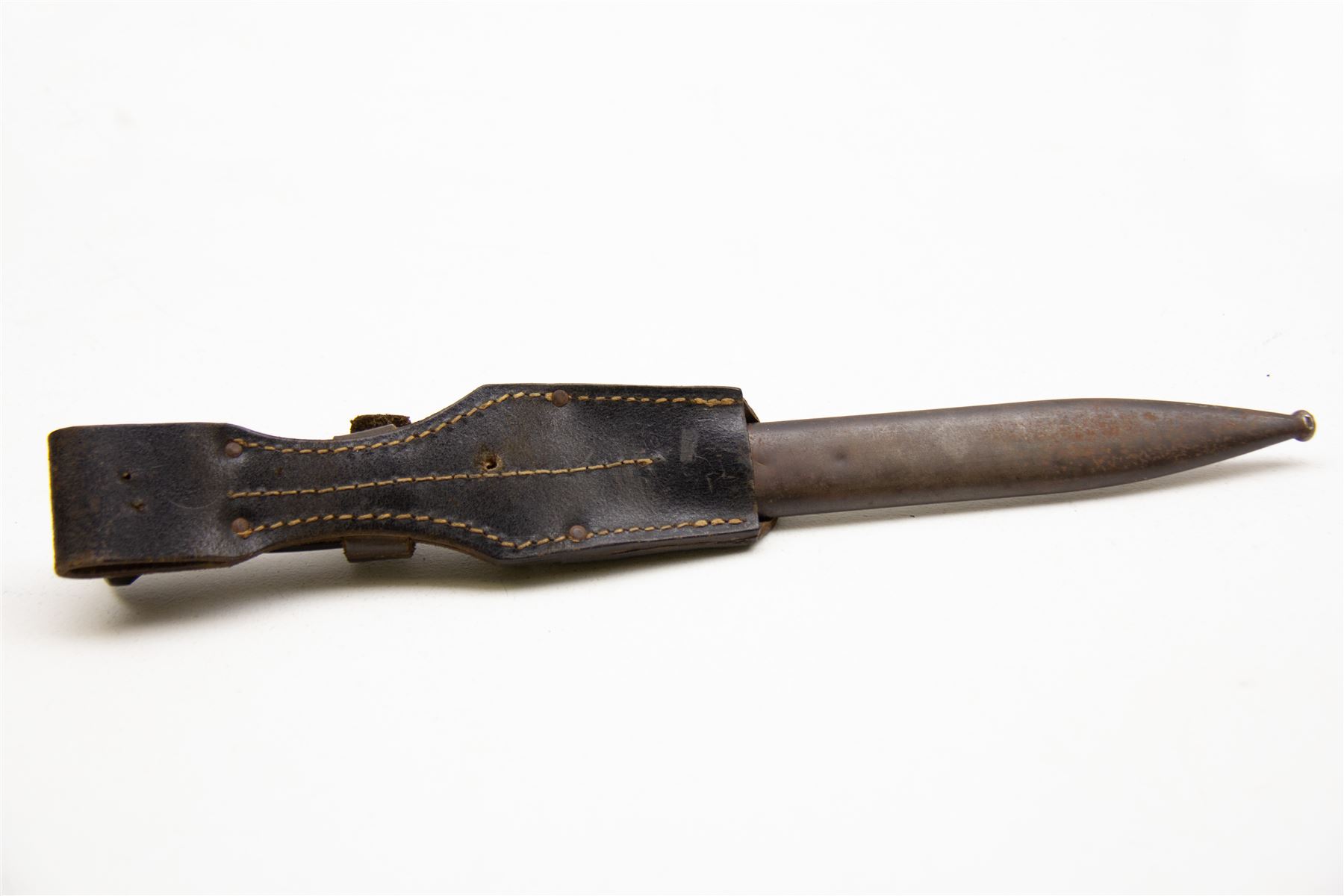 WWII German K98 bayonet by Clemen & Jung, the 24.5cm fullered blade marked 8647 h, with Bakelite grip and bluing to metal blade; in steel scabbard with corresponding numbers and leather frog, L42cm overall