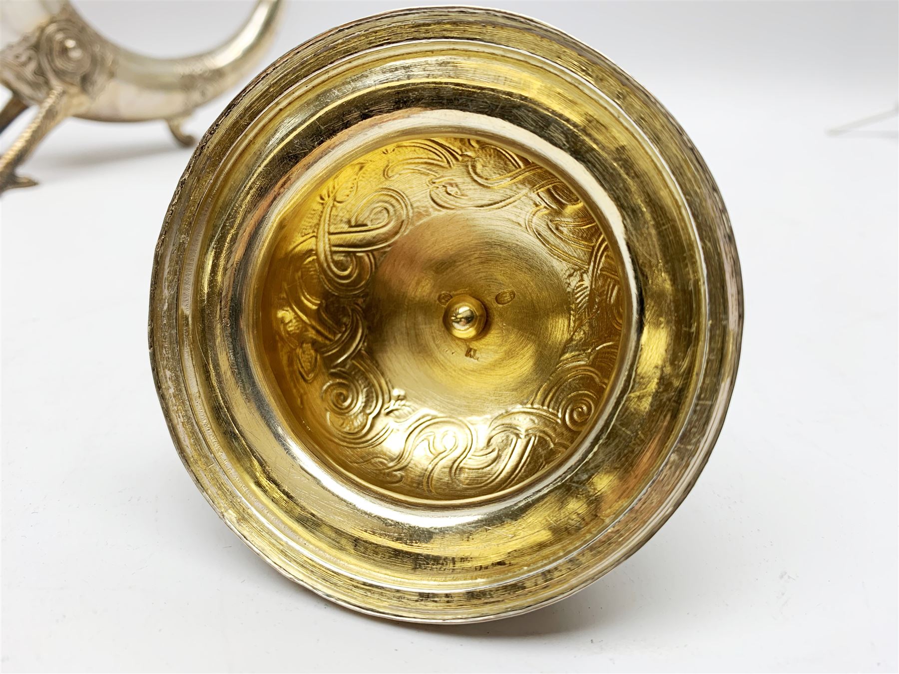 Late 19th century Danish silver drinking horn and cover, the body with hexagonal and beaded finial, raised upon two talon feet and further scroll foot, chased with scrolling foliate and zoomorphic bands, the detachable domed cover with conforming decoration surmounted by a figure holding a hammer, the cover interior impressed with maker's mark (partly worn and indistinct), alongside Danish Three Towers mark for 1881, with the Assay Master mark for Simon Groth (1863-1904), H23.5cm, weight 14.75 ozt (459 grams)

