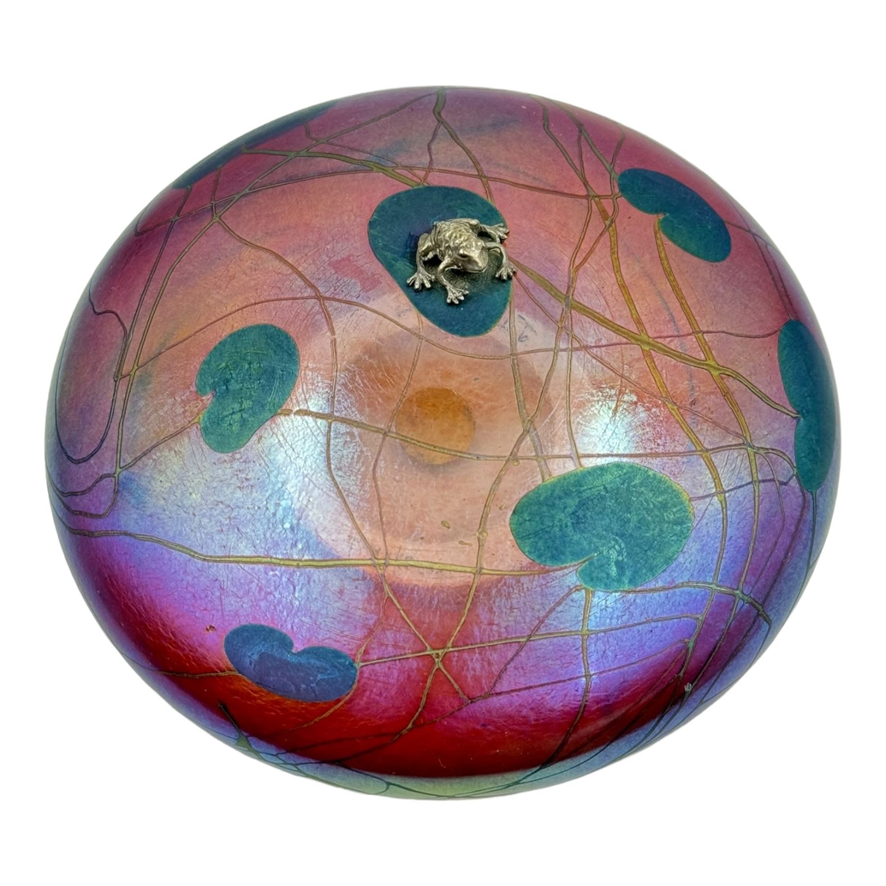 John Ditchfield for Glasform disc paperweight in iridescent cranberry with green lily pads and silver hallmarked frog to top, D14cm