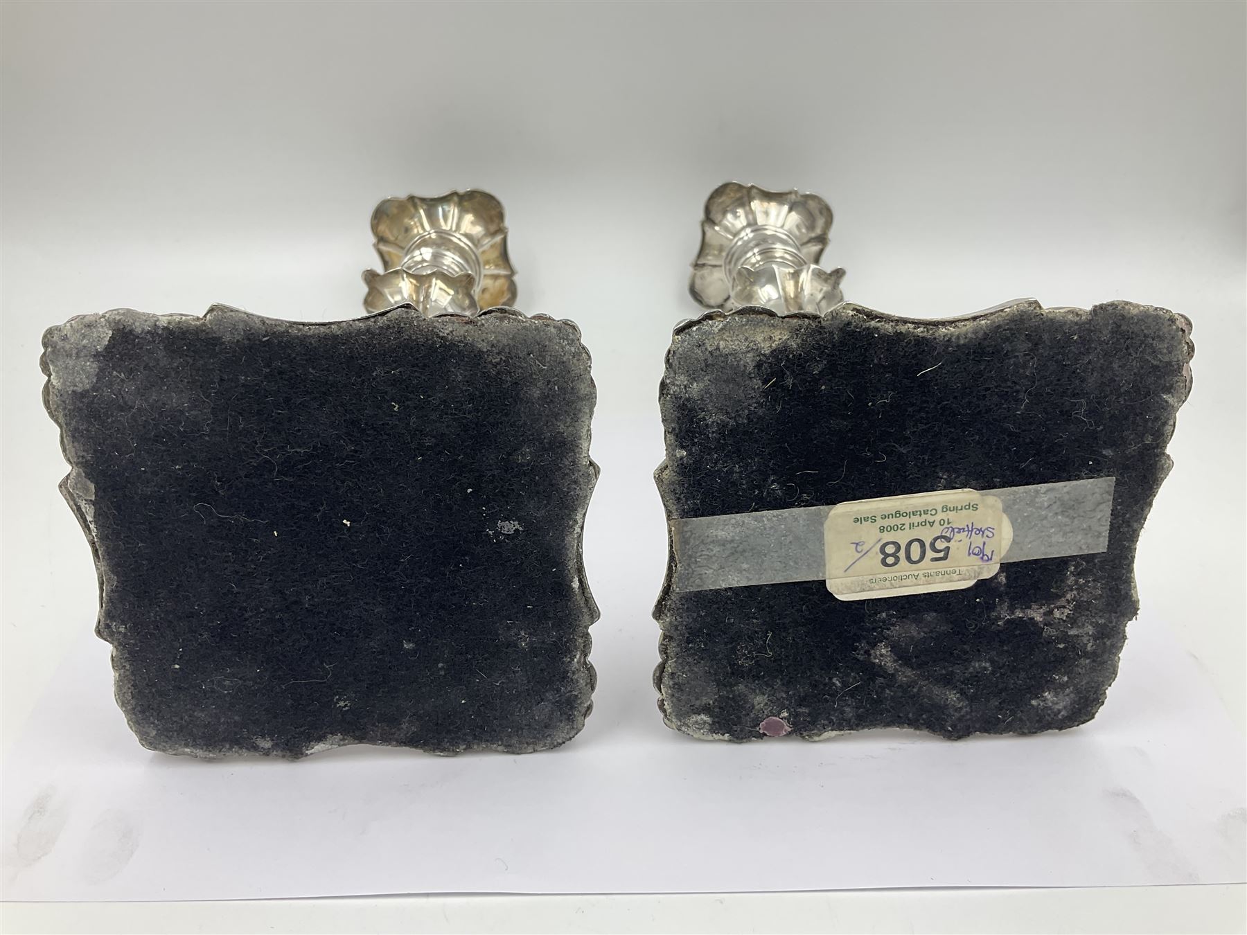 Pair of late Victorian silver mounted candlesticks, each of knopped and part fluted form, upon square stepped base with anthemions to each corner, with conforming sconces, hallmarked to removable sconces and foot, Thomas A Scott, Sheffield 1901, H25.2cm