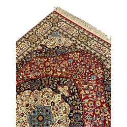Persian Kashan design rug, central medallion in a field of scrolling branch and stylised flower heads, repeating panelled border