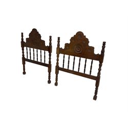 Pair Spanish stained beech single 3' bedsteads, spindle turned backs and carved with scrolling floral decoration 
