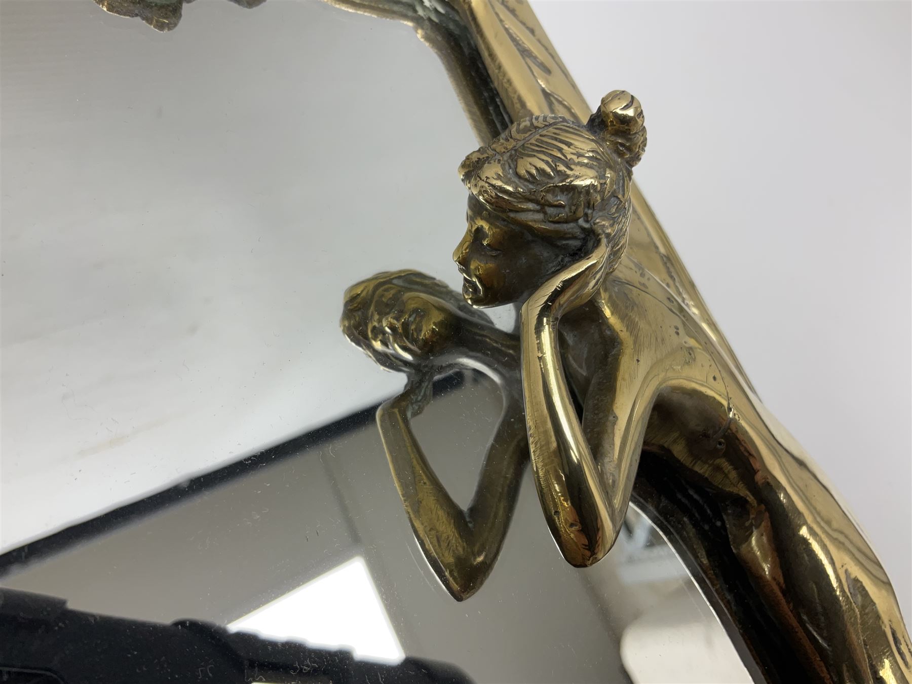 Art Nouveau style mirror in the manner of WMF, decorated with a female figure and floral motifs, the easel support verso with spurious WMF, H35cm