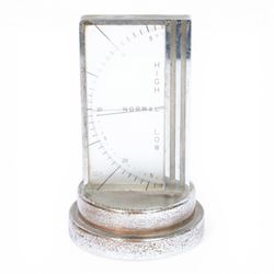 Art Deco chrome plated desk aneroid barometer by Zeiss Ikon, with frosted glass panel to rear, upon raised on a stepped circular base with instructions printed on the underside, H16cm