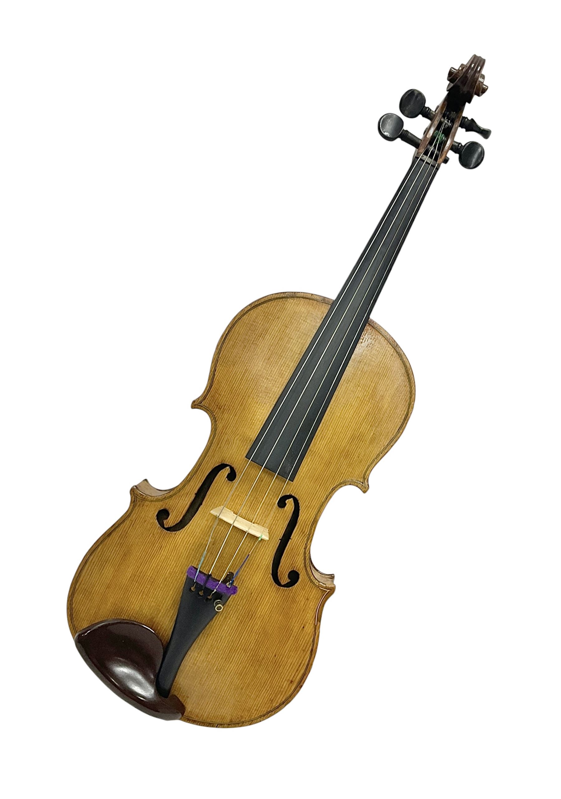 Copy of a full size Stradivarius violin, with an ebonised fretboard, tailpiece and tuning pegs, with a polished chin rest  Length 60cm