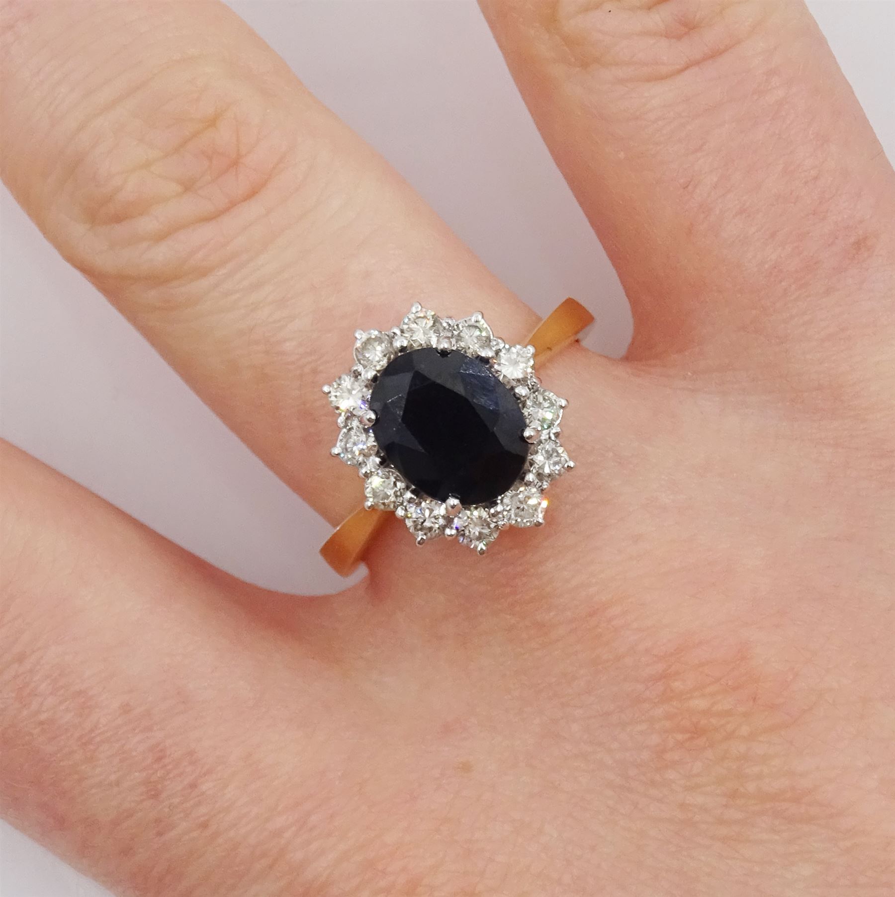 18ct gold oval sapphire and round brilliant cut diamond cluster ring, hallmarked, total diamond weight approx 0.55 carat, sapphire approx 2.60 carat
