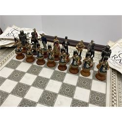 Franklin Mint Indian ' The Raj ' chess set with marble effect chess board within a mahogany stained frame raised on a brass mounted pedestal base with single fitted drawer, the playing pieces depicting figures from the 1857 Raj mutiny 52cm square H68cm