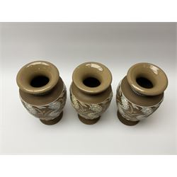 A set of three 19th century Doulton Lambeth silicon ware vases, each of a baluster form with white foliate decoration, with impressed and incised marks beneath, including makers marks, H24cm. 
