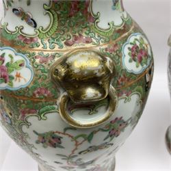Pair of 19th century Chinese Famille Rose vases and covers, each of baluster form with twin gilt lion mask ring handles to shoulders, the flattened domed covers with gilt temple lion finials, each decorated with alternating reserves of bijin and attendants, and birds and butterflies amongst blossoming peonies, against a gilt ground profusely decorated with stylised scrolls, H32.5cm