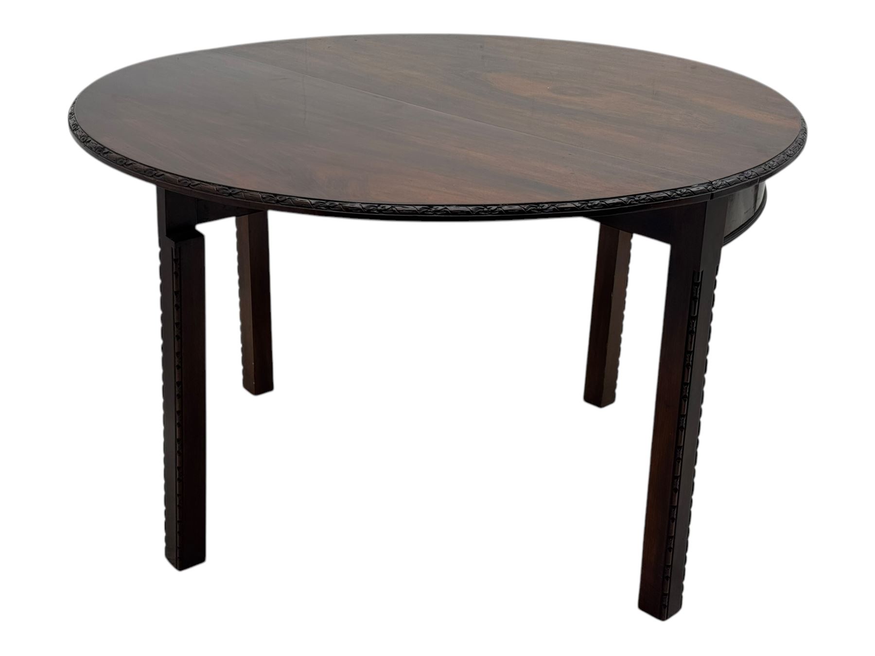 Early 20th century mahogany demi-lune table, the circular top with carved foliate border, raised on square section supports with relief carved edges