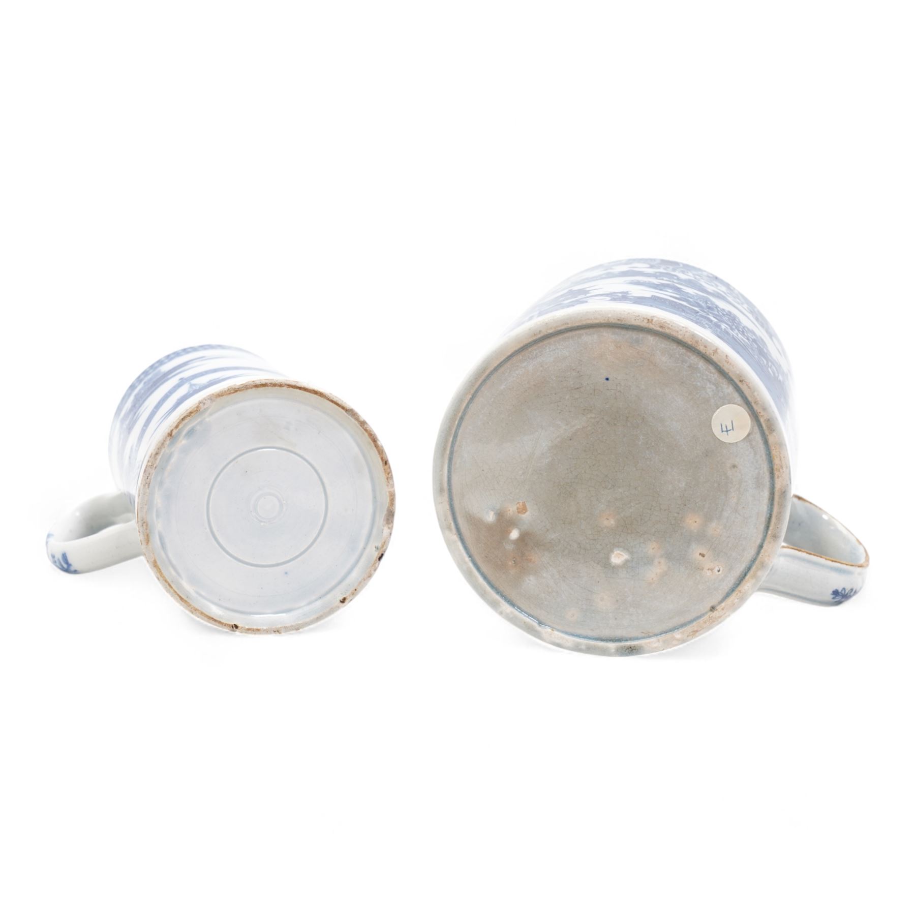 Early 19th century pearlware blue and white willow pattern tankard, possibly Swansea Pottery, together with another 19th century pearlware tankard (2)
