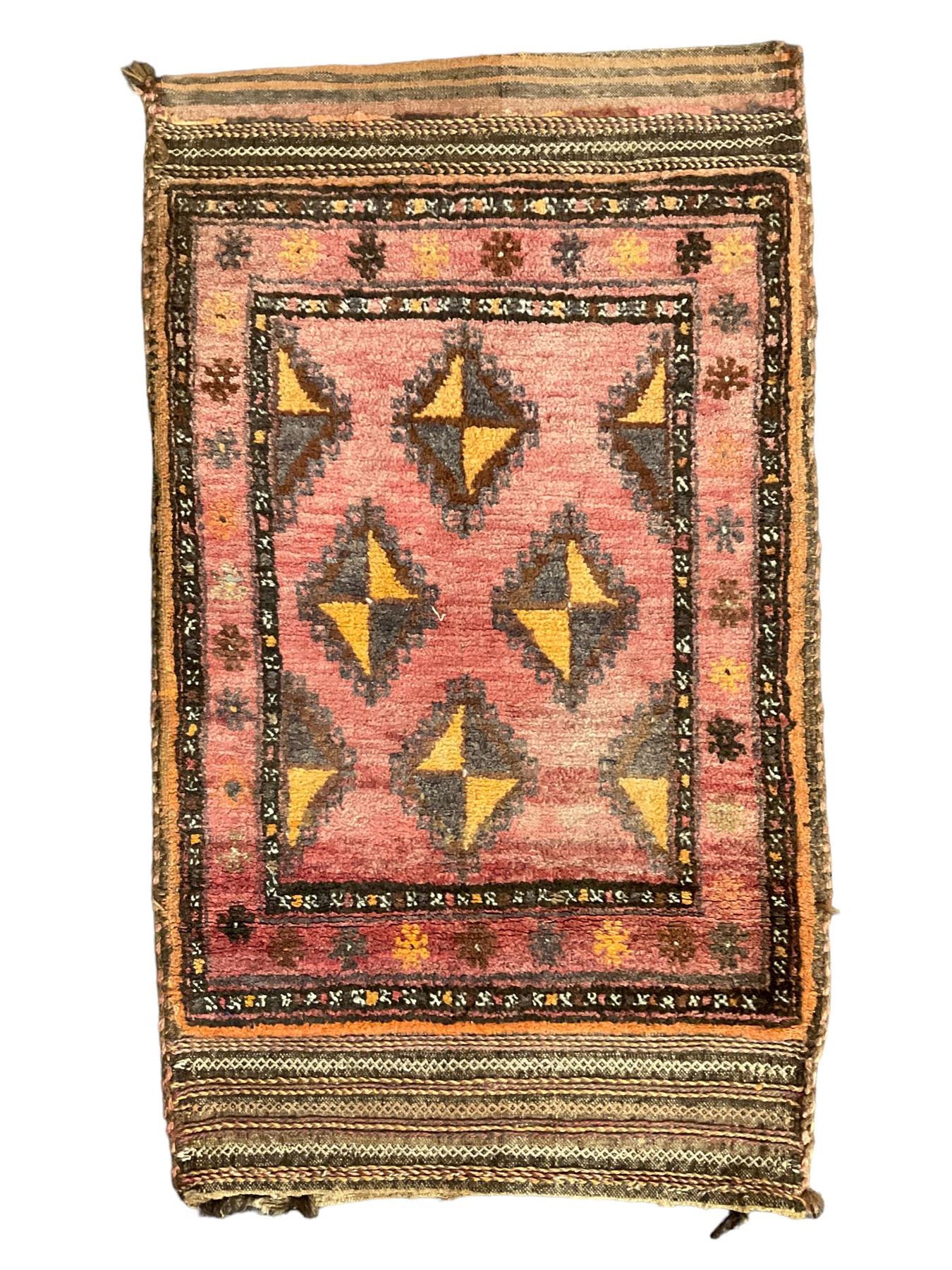 Antique Persian red ground saddle bag, decorated with all-over Boteh motifs, geometric patterned border (127cm x 68cm); Persian indigo ground saddle bag, decorated with two geometric ivory lozenges (113cm x 62cm); Persian red ground saddle bag decorated with lozenges and multi-band border (110cm x 65cm) 