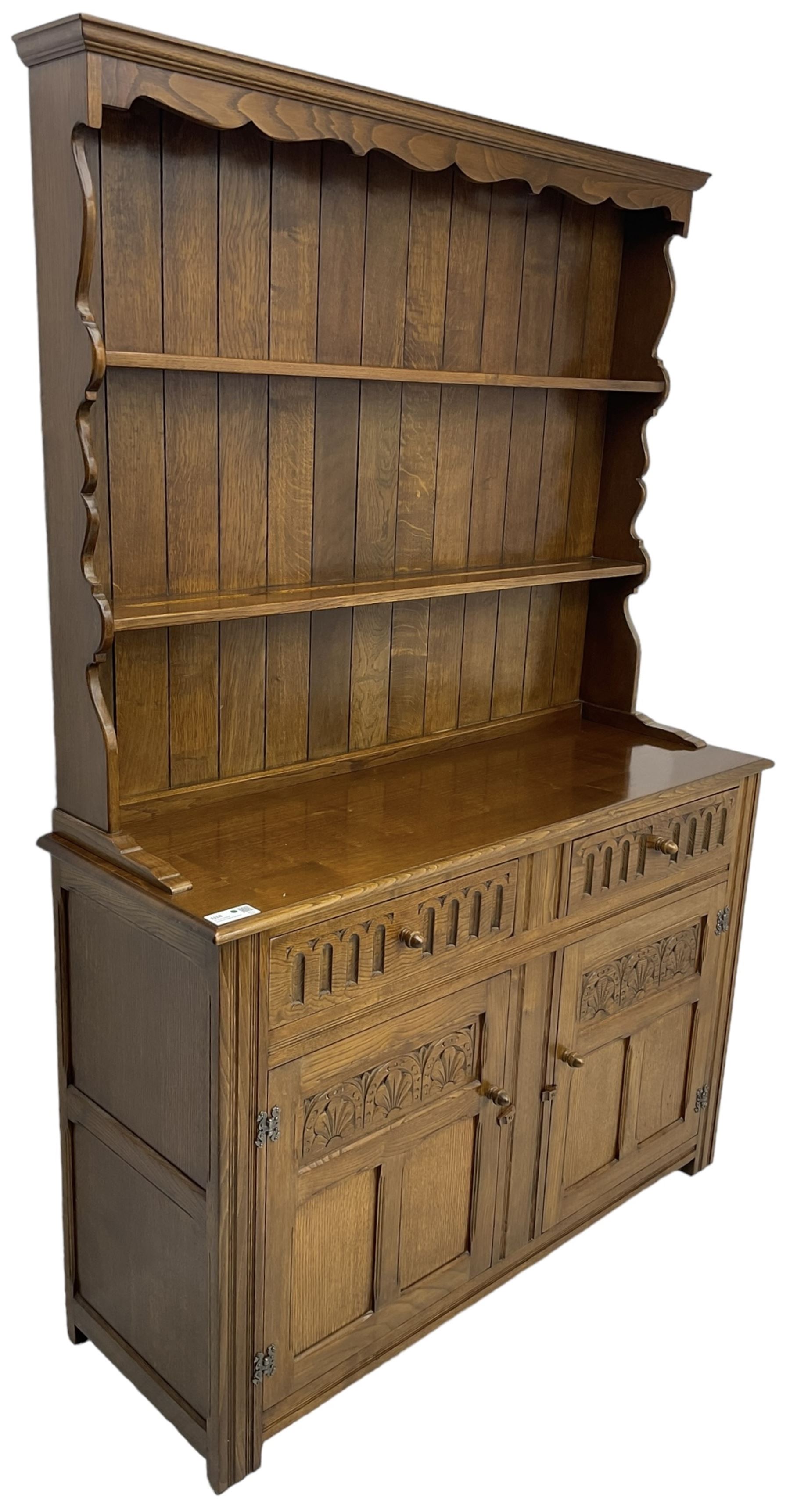 Mid-20th century oak dresser, raised two heights plate rack over two drawers and two cupboards