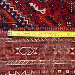 Qashqai wool carpet, red diamond-shaped field decorated with three stepped pole medallions, floral rosettes and scattered stylised motifs, within dark blue spandrels and multiple geometric guard borders