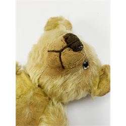 1930s teddy bear, possibly Farnell, with wood wool filled blond mohair body, the revolving head with original clear glass eyes, shaved muzzle with vertically stitched nose and mouth and jointed limbs with five-stitch claws H18.5