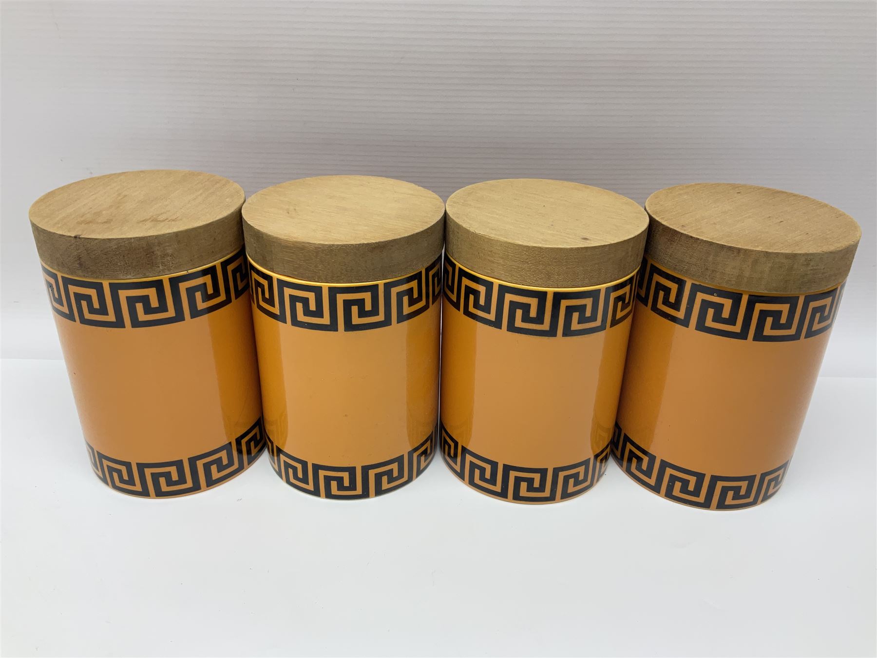 Four Portmeirion storage jars with Greek key pattern on an orange ground, together with Tams Ware tea service and other ceramics