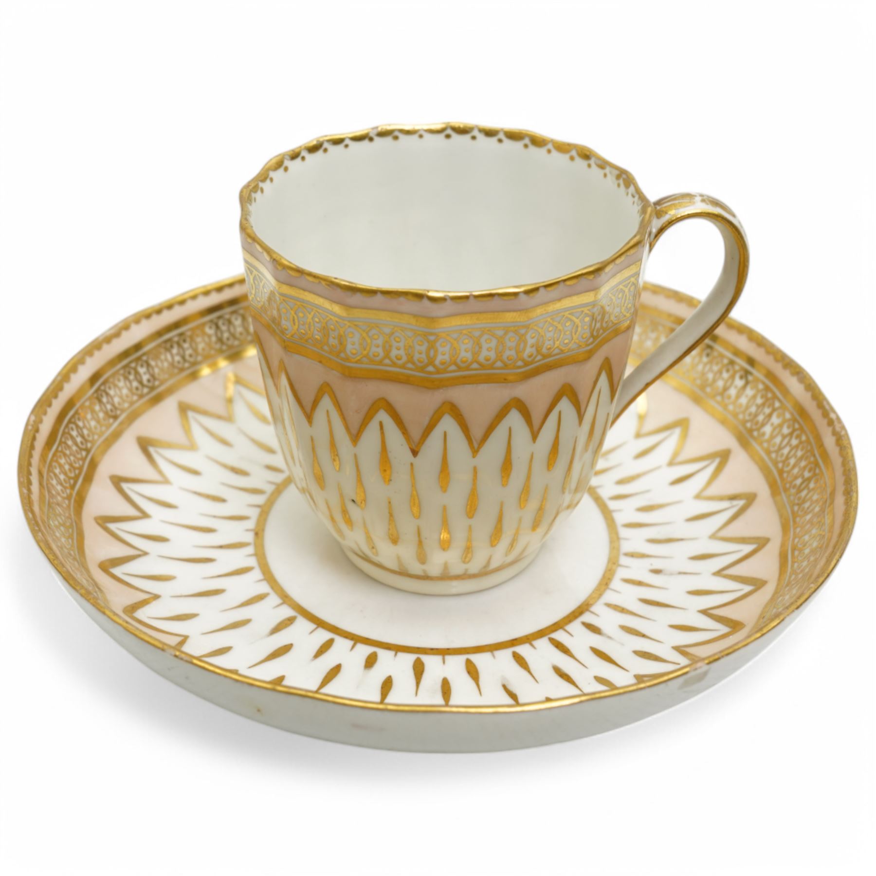 Derby coffee cup and large saucer, pattern 119, c.1795, the apricot ground decorated with gilt teardrop motifs and intricate Vandyke boarder, with crown, D mark and crossed batons in puce to base, decorator's mark no. 2 for Joseph Stables