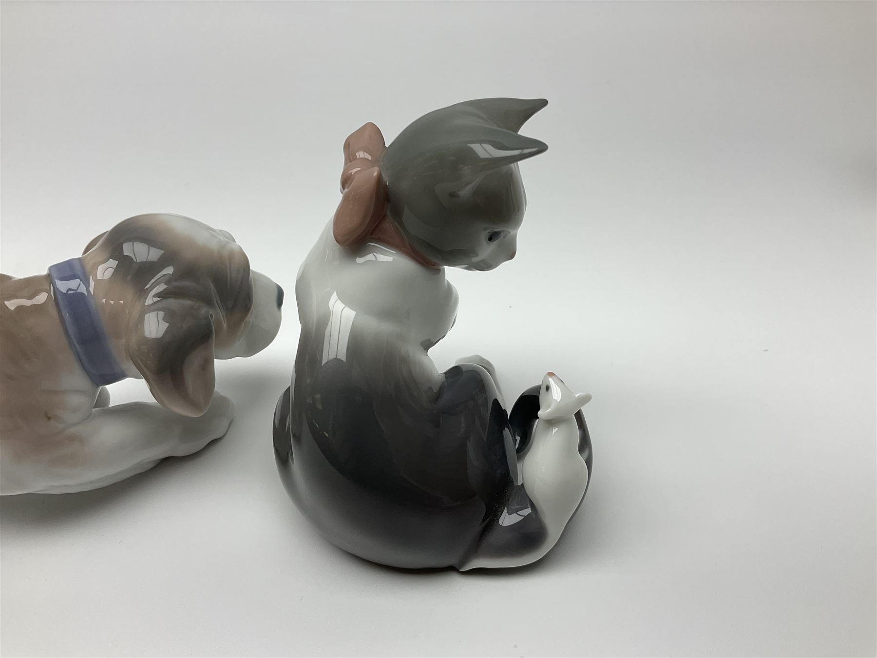 Five Lladro figures, comprising Cat and Mouse no. 5236, That Tickles no. 5888, Gentle Surprise no. 6210, Little Hunter no. 6212 and Resting Polar Bear no. 1208, largest H12cm