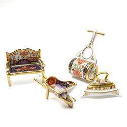 Collection of Royal Crown Derby miniature wares in Imari type patterns, comprising two champagne buckets with miniature champagne, milk churn, kettle, watering can, lawn roller, wheelbarrow, bench and kettle, five with boxes (10)