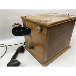 Early-mid 20th century internal telephone system, comprising exchange box with attached TMC rotary telephone and dictograph with Bakelite handset and support upon stained wood case, and 1960s black Bakelite telephone model 312L with G.P.O sticker beneath, largest H30.5cm W36.5cm D30cm