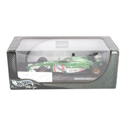 Three signed limited edition 1:18 scale Formula One models, comprising Hot Wheels Jordan EJ12 signed by Takuma Sato, Hot Wheels Jaguar Racing R2 signed by Eddie Irvine and a Minichamps Williams F1 Team model signed by Jenson Button, 1:18 scale model, all boxed