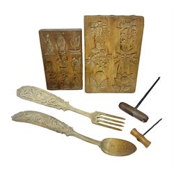 Two wooden biscuit moulds, carved loving spoon and fork, and two bradawls 