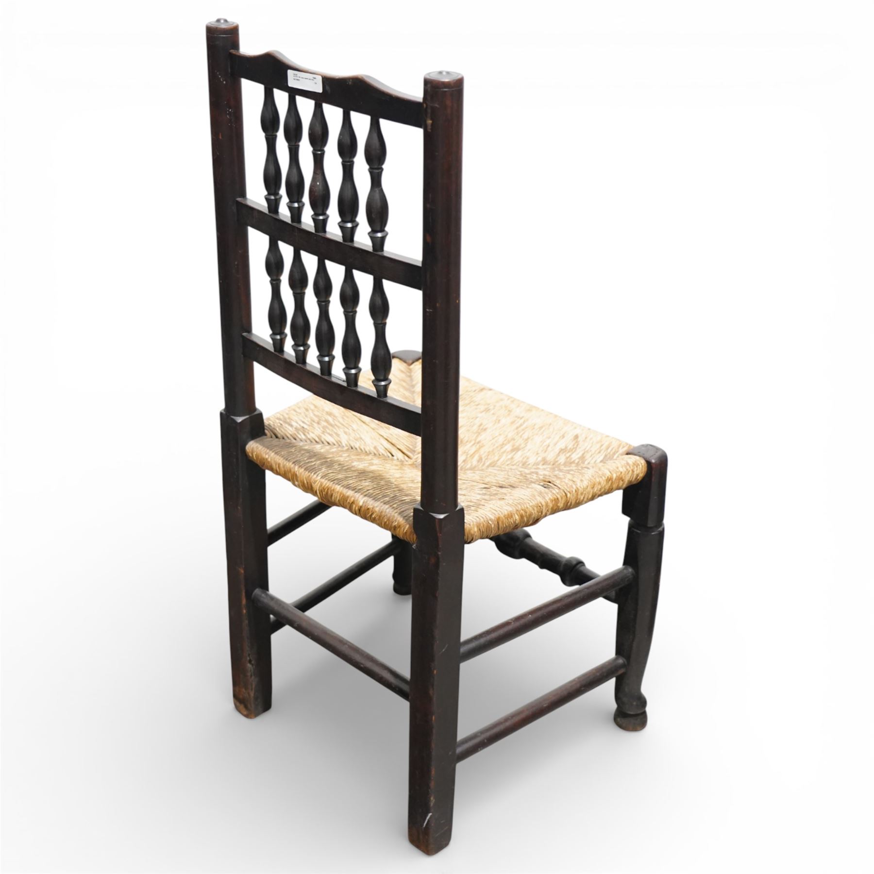 Set of five 19th century elm spindle back chairs, with shaped crest rails above double rows of turned spindles, rush seats, turned legs joined by stretchers supported on turned pad feet