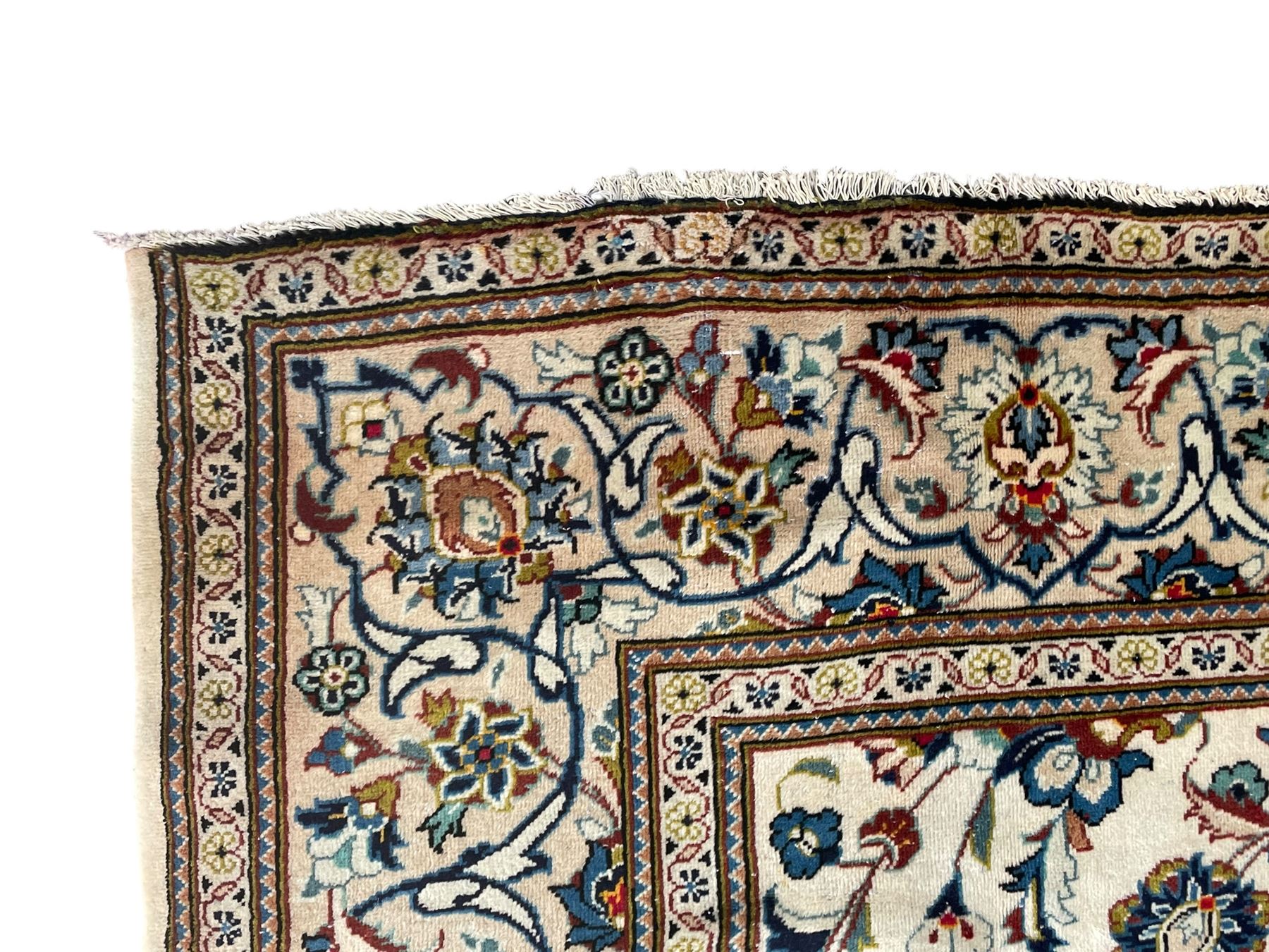 Persian Kashan ivory ground carpet, the field decorated with scrolling branches with foliate and palmette motifs, repeating border with stylised plant motifs, within floral and geometric pattern guard stripes 