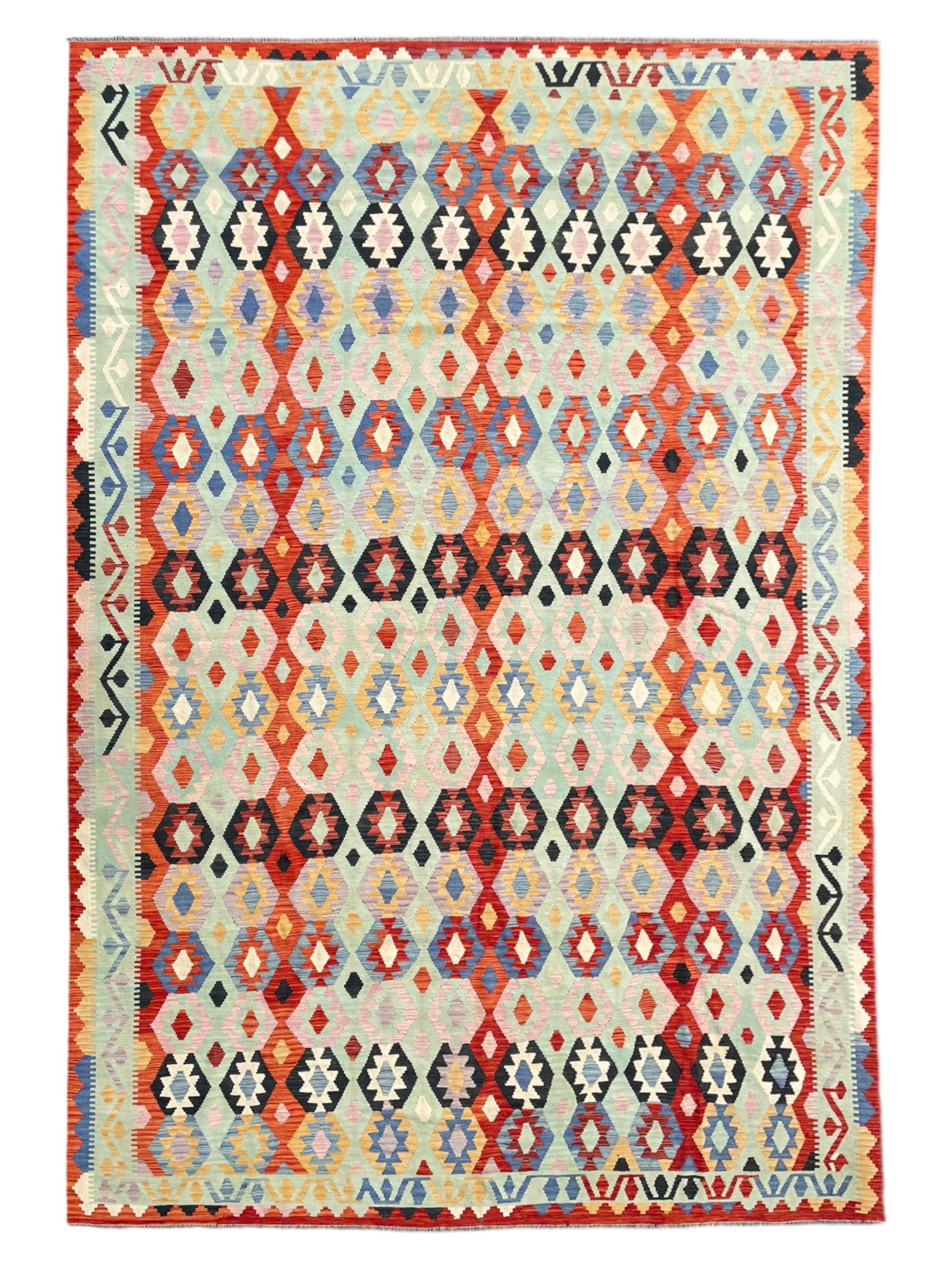 Large Kilim carpet, overall geometric design, decorated with lozenges within a tailing border, geometric guard stripes 
