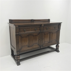  Early 20th century oak sideboard, raised shaped back, two drawers with blind fret work above two cupboard doors, cup and cover supports on shaped sledge feet joined by stretchers, W153 cm, H109cm, D60cm  