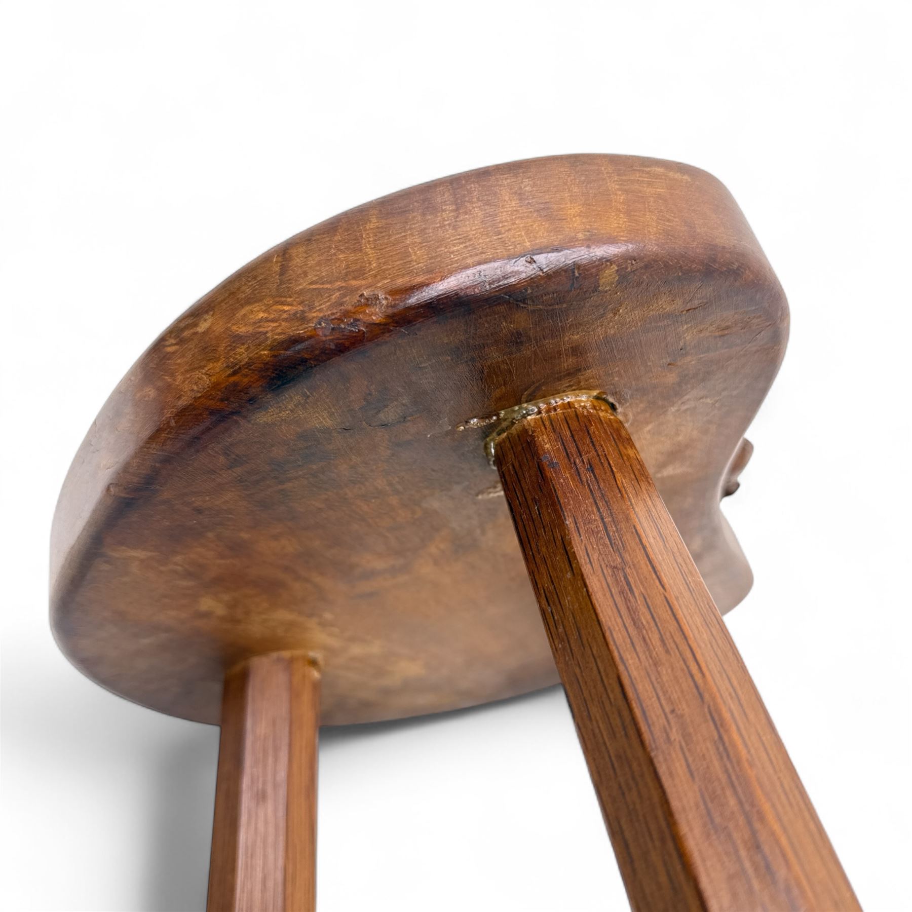 Mouseman - oak three-legged calf stool, kidney-shaped seat carved with the signature mouse motif, by the workshop of Robert Thompson, Kilburn